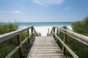 A wooden boardwalk leading to a beach with clear blue water and a sandy shore. - Gulf front, Breathtaking Views From Both Indoors And Out, 1st level condo (Santa Rosa Beach)