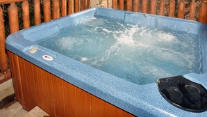 A hot tub with a control panel and a wooden deck surrounding it. - Jacuzzi | Pigeon Forge | Pool Table | WiFi | Hot Tub (SEVIERVILLE)