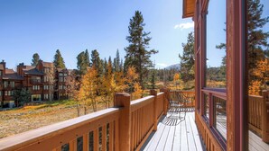 A wooden deck with a view of a residential area and trees. - Exquisite Home with Ski-In Access, PRIVATE HOT TUB, Stunning Views. FOUR (Breckenridge)