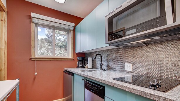 A kitchen with a microwave, sink, and dishwasher. - Completely Renovated, Downtown Studio - Top Floor Unit. Ski In Access | PM7D (Breckenridge)