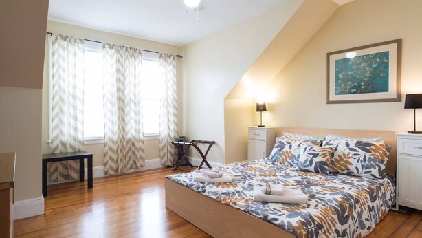 A bedroom with a bed, a desk, a chair, a ceiling fan, and a painting on the wall. - Salem 3rd floor 3BR Apartment (Salem)