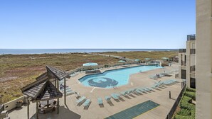 A pool area with lounge chairs and a view of the ocean. - Phoenix VII 213 | Beachfront | Pools | Fitness Center | My Beach Getaways (Orange Beach)