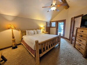 A bedroom with a wooden bed, a ceiling fan, a dresser, and a window with a view. - Keystone Ranch Luxury | 5BR + Private Hot Tub (Keystone)