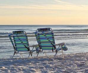 Two beach chairs with striped fabric facing the ocean. - Corner condo at Destin Towers overlooking Gulf-front pool & beach! (Destin)