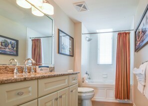 A bathroom with a marble countertop, a sink, a toilet, and a shower. - Gulf Front ~ 11th Floor ~ Beachfront Pool ~3BR Silver Beach East 1103 (Destin)