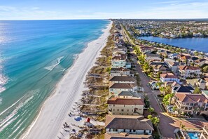 A coastal residential area with beachfront properties, a clear sky, and a calm sea. - Stylish Beach Home w/Private Elevator & Beach Access (Destin)