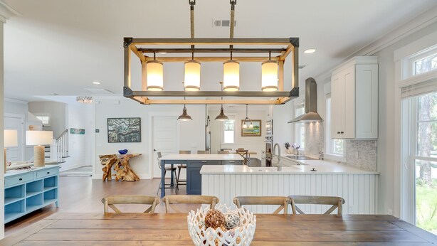 A spacious kitchen with a central island, pendant lighting, and a view of the outdoors. - 3B Hickory Lane-CUSTOM built house!  200 Yards till your feet are in the sand (Hilton Head Island)