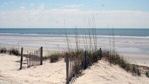 A beach with a wooden fence and sand dunes. - 47 S. Beach Ln | 4 Bedroom 5th Row Ocean | Pet Friendly | STR #029802 (Hilton Head Island)