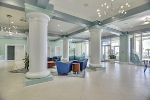 A spacious lobby with high ceilings, large columns, and modern seating areas. - Boardwalk Beach Resort Family Getaway with Splash Zone and Gulf Views (Panama City Beach)