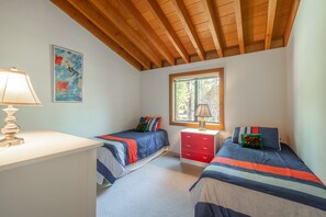 A bedroom with two beds, a desk, a window, and a painting on the wall. - Lakefront Northshore Townhome pano lake views, HOA private beach pool tennis (Tahoe City)