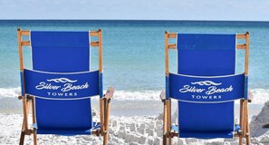 Two beach chairs with "Silver Beach Towers" branding on a sandy beach with ocean in the background. - Serene Beachfront Condo w/ Gulf Views & Close Dining in The Heart of Destin! 💙☀ (Destin)