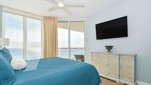 A bedroom with a bed, a television, a cabinet, and a window with curtains. - Serene Beachfront Condo w/ Gulf Views & Close Dining in The Heart of Destin! 💙☀ (Destin)