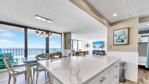 A spacious kitchen with a large island, modern appliances, and a view of the ocean. - BeachFront for 8~Remodeled~Pool~2BR Edgewater 611 Tower 2 (Panama City Beach)