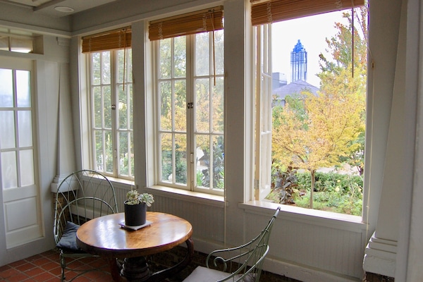 Entrance/Sunroom overlooks the front yard with skyline in the background.