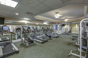 A gym with treadmills, elliptical machines, and weight machines.