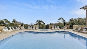 A clear blue swimming pool with lounge chairs and a hot tub. - 2 Bed/2 Bath Villa North Shore Place Near Coligny Beach, Rooftop Pool and Spa (Hilton Head)