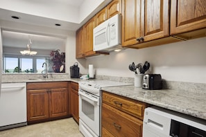 Enjoy cooking in this well-equipped kitchen with a microwave, toaster, and dishwasher.