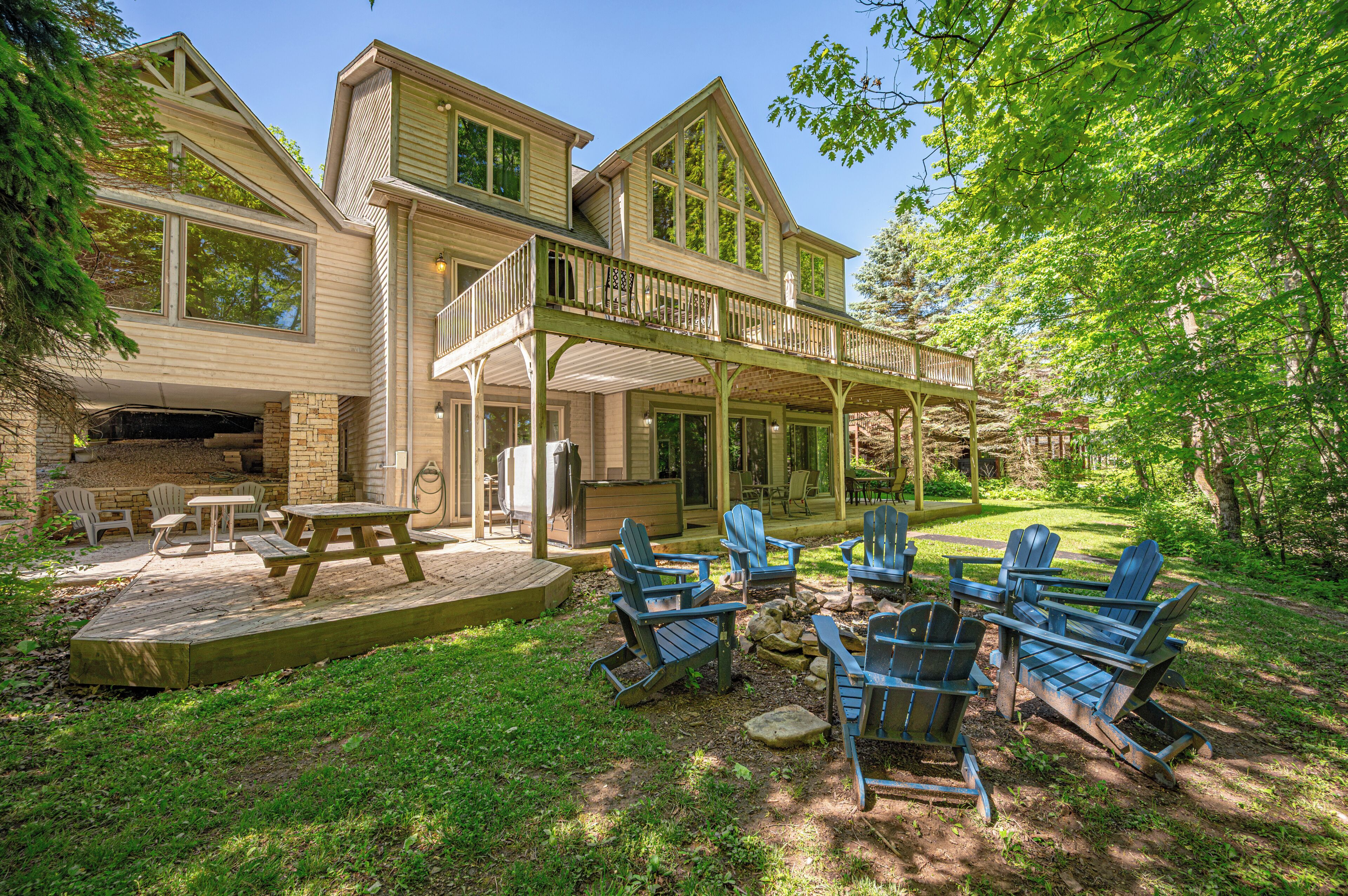 A two-story house with a covered patio and outdoor seating area.