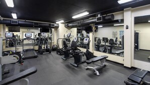 A gym with various exercise equipment, mirrors, and a clock on the wall. - Bright 4th Floor Condo w/ Gulf Views & Modern Touches on Scenic 98 in Destin! 🏖 (Destin)