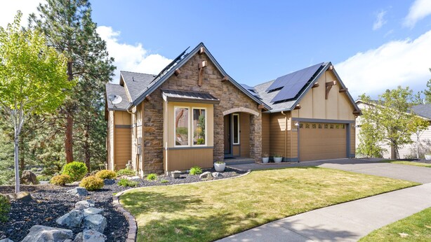 A two-story house with a stone facade, a garage, and a well-maintained lawn. - Quinn Creek - Gorgeous and Updated! Perfect Location in NW Bend, Pool Table, 20 Min To Bachelor! (Bend)