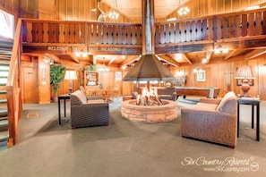 Relax by the fire pit in the spacious lobby, surrounded by comfortable seating and natural light.