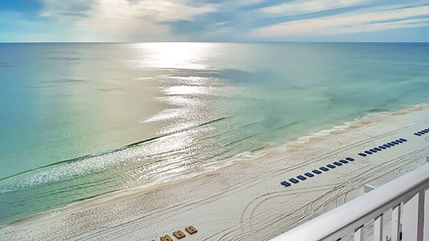 A beach with clear water and a sunny sky. - GULF FRONT CONDO! SLEEPS UP TO 6! (Panama City Beach)