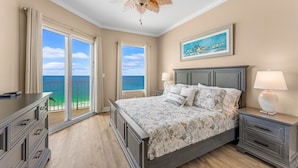 A bedroom with a bed, nightstands, a dresser, and a ceiling fan. - GULF FRONT CONDO! SLEEPS UP TO 6! (Panama City Beach)