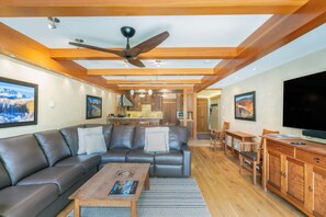Relax in this stylish living area with a sofa, dining table, and flat-screen TV.
