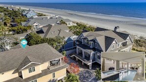 A coastal residential area with houses, a beach, and a pool. - 77A Dune-Awesome Ocean Views, Pool, Spa, Pool Table, Elevator & Much More (Hilton Head Island)