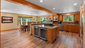 A spacious kitchen with wooden cabinets, a central island, and built-in appliances. - Riverfront, Hot Tub, Starlink Internet, Basketball! (Durango)
