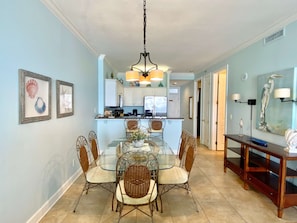 Enjoy meals in this dining area with a glass-top table and six comfortable chairs.
