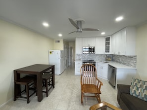 Enjoy cooking in this well-equipped kitchen with an oven, microwave, and stainless steel range hood.