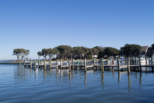 Relax on the waterfront with a serene view of calm waters and lush greenery.
