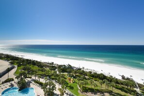 A resort with a pool, beach, and ocean view.
