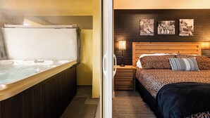 A room with a wooden bed, a headboard with animal prints, a small wooden nightstand, a wall-mounted lamp, and a framed animal print on the wall. - Bright and Airy Mountain Townhome. Walk to Shops, Dining, Trails + Hot Tub (Park City)