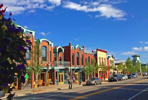 A street lined with colorful buildings, including a restaurant and a bank.