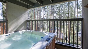 A hot tub on a balcony with a view of tall trees. - Chimney Ridge Sunflower Townhome: Walk to Lift, Private Hot Tub (Breckenridge)