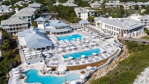 A resort with multiple swimming pools, sun loungers, and covered areas.