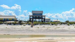 A beachfront property with a multi-level house featuring a balcony and a staircase leading to the beach. - Large 5 bedroom, 3-1/2 bath BEACHFRONT Home, Just Steps to Peaceful Beach (Port Saint Joe)