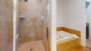 Bathtub, hair dryer, towels, shampoo
