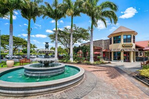 Stroll through the serene outdoor space, surrounded by lush greenery and a tranquil circular fountain.