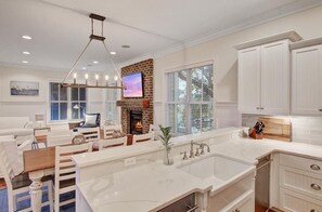 Enjoy a bright and welcoming space with a large island, fireplace, and plenty of natural light.