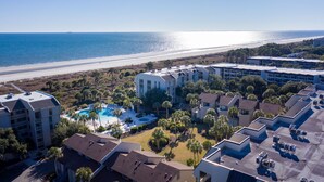 A resort with a pool, beachfront view, and multiple buildings.