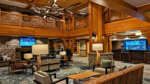 A spacious lobby with a high ceiling, wooden beams, a stone fireplace, and a reception desk. - Marriott Grand Res #4256 - Next door to Heavenly Gondola - Large Studio - Gondola View (South Lake Tahoe)