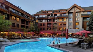 A hotel with multiple swimming pools, outdoor seating, and a stone facade. - Marriott Grand Res #4256 - Next door to Heavenly Gondola - Large Studio - Gondola View (South Lake Tahoe)