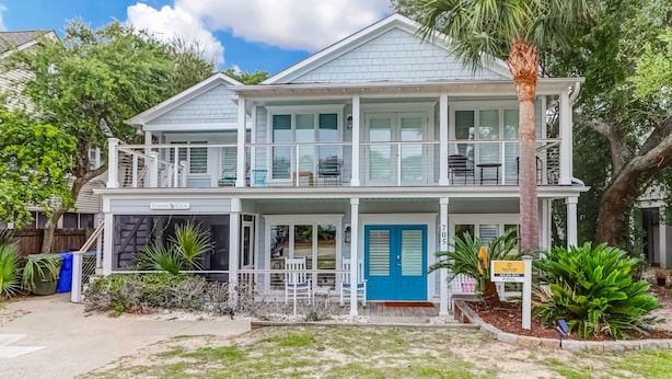 A two-story house with a covered porch, a pool sign, and a mailbox. - Backyard Oasis with Private Pool & Hot Tub! Close to Beach - 705 Carolina (Isle of Palms)