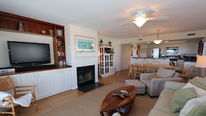 A living room with a fireplace, television, and seating area.