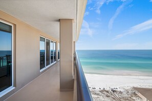 Enjoy breathtaking ocean views from this spacious balcony with large windows and a railing.