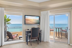 Enjoy ocean views from the balcony, featuring a dining table and chairs.