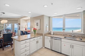 Enjoy ocean views while cooking and dining in this kitchen with a large island and dishwasher.